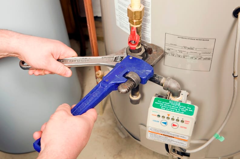 Plumber repairing a water heater valve in El Cajon